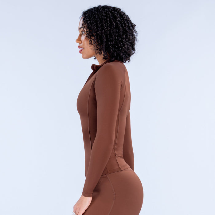 Brown zip-front athletic bodysuit with long sleeves and fitted torso