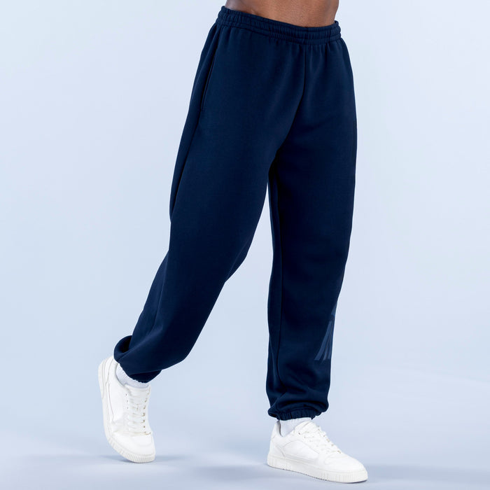 Navy cuffed jogger pants with elastic waistband and tapered cuffed hems