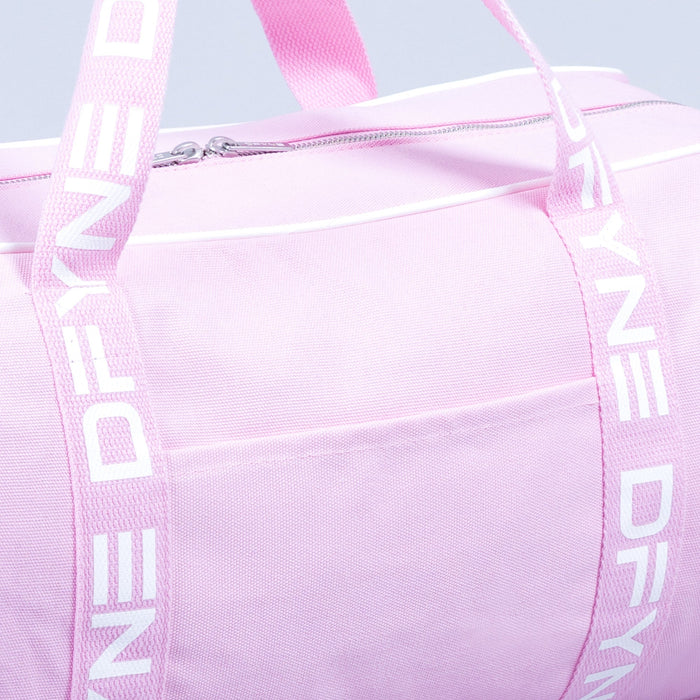 Light pink duffle bag close-up: zip pocket front and webbing shoulder straps.
