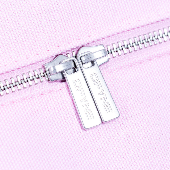 Silver zipper pull with logo tag on light pink duffle bag.