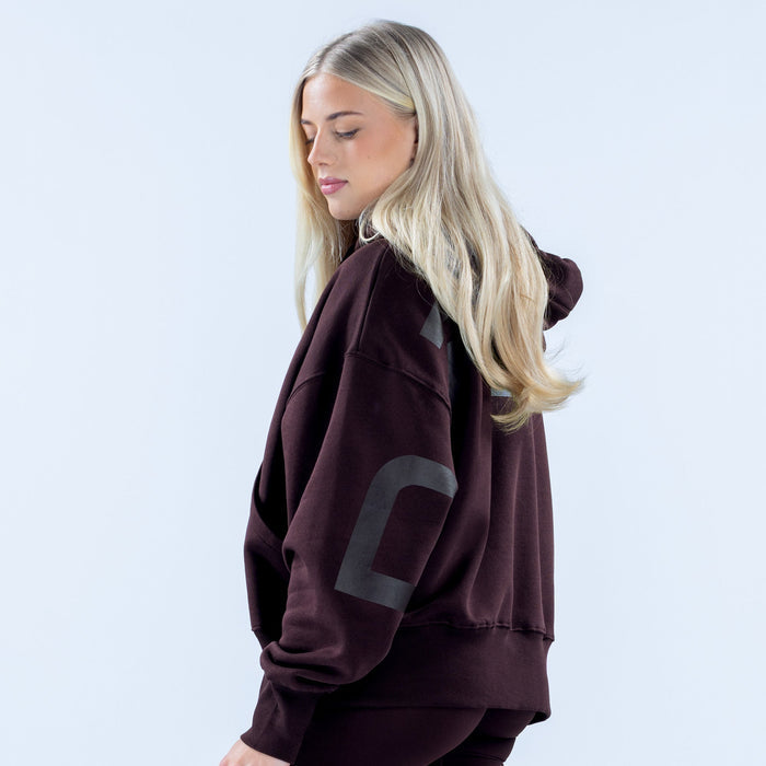 Burgundy pullover hoodie with hood and partial 'FLY' graphic on sleeve