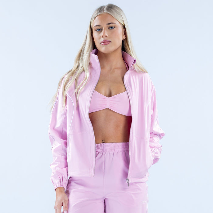Pink track jacket worn open with full-zip and elastic waistband