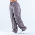 Dark gray track pants with white piping, elastic waistband, logo on thigh
