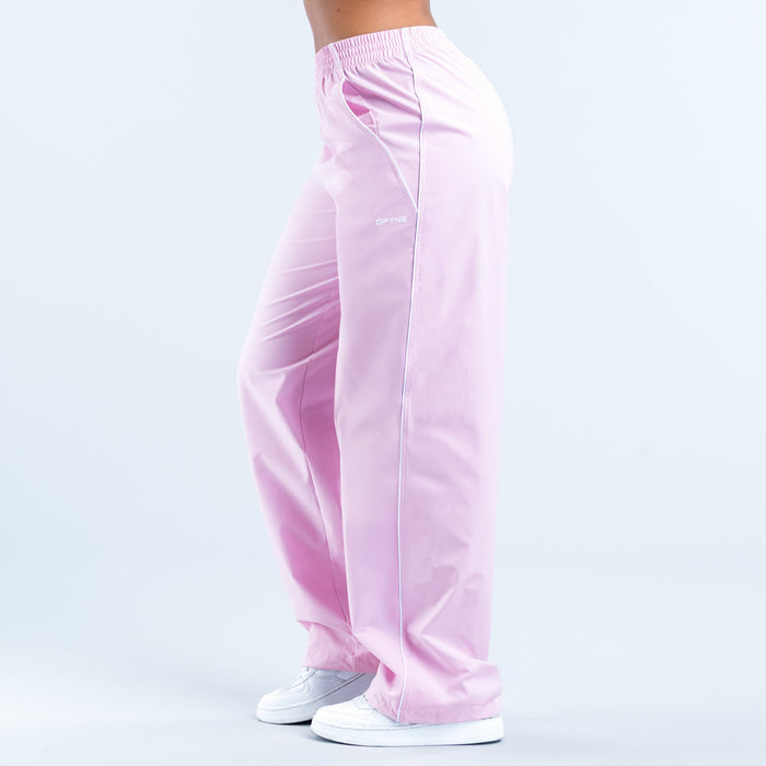 Pink track pants with elastic waistband, tapered leg cuffs, small logo on calf