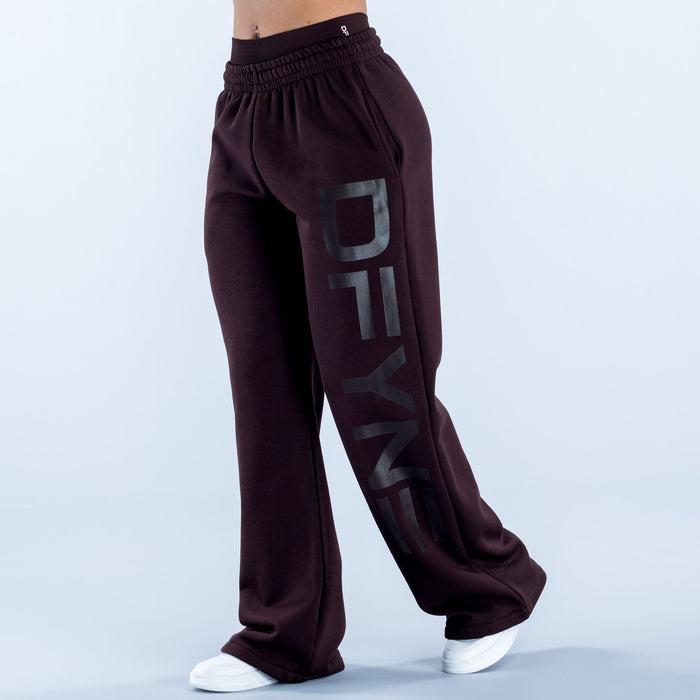 Dark maroon wide-leg jogger pants with elastic waistband, cuffed hems, large side print