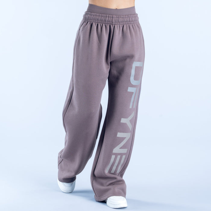 Taupe wide-leg joggers with elastic waist and vertical 'DENY' logo graphic