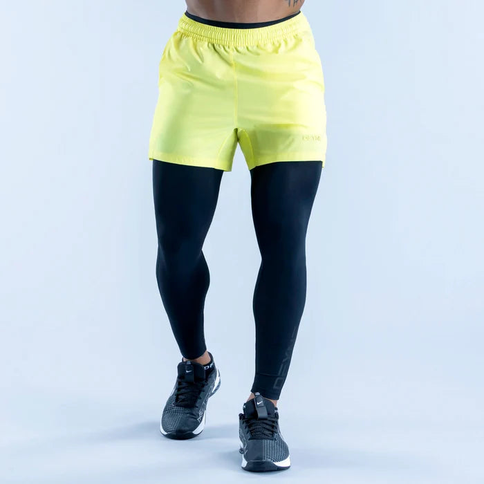 Two-tone compression base layer bottoms with neon yellow waistband and black fitted legs