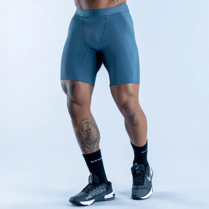 Unbound baselayer shorts in teal, form-fitting with waistband and leg seams
