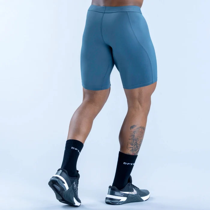 Unbound baselayer shorts in teal, rear view with contoured seams