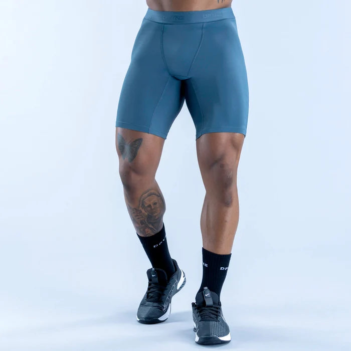 Unbound baselayer shorts in teal, side view with flat waistband and smooth finish