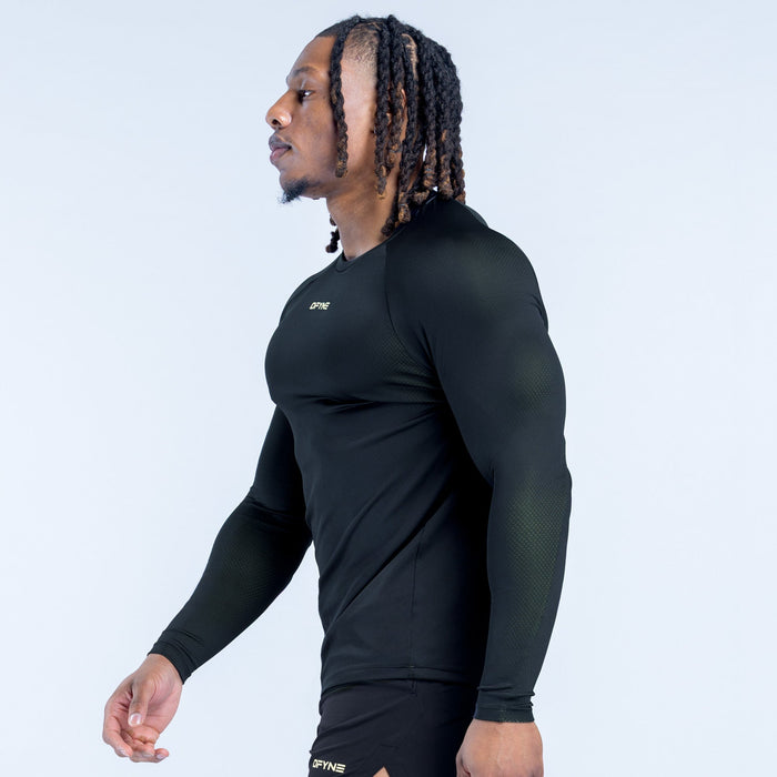 Black long-sleeve training T-shirt side view with crew neck and logo at hem.