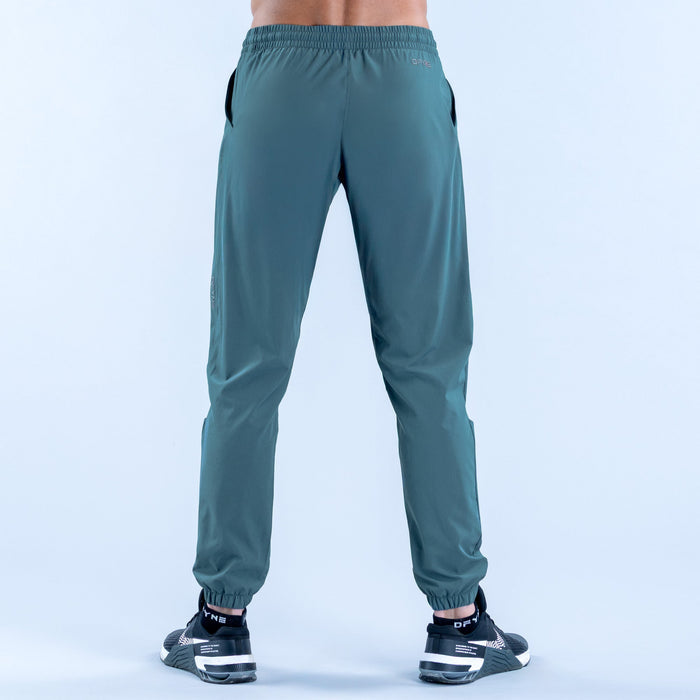 Teal training jogger pants, back view, elastic waist and tapered ankle cuffs
