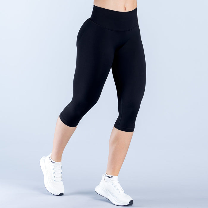 Black 3/4 capri leggings with straight waistband, smooth slim-leg fit.