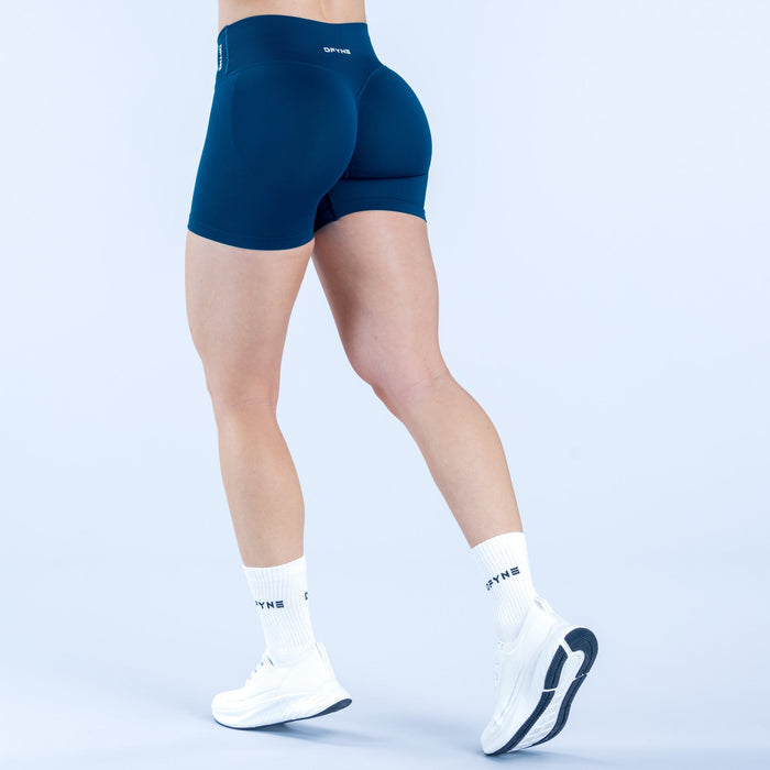 4.5-inch performance shorts in dark teal, back view, mid-thigh length.