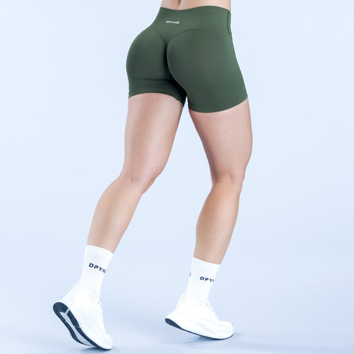 Dark green 4.5 in athletic shorts with curved seam and small back logo