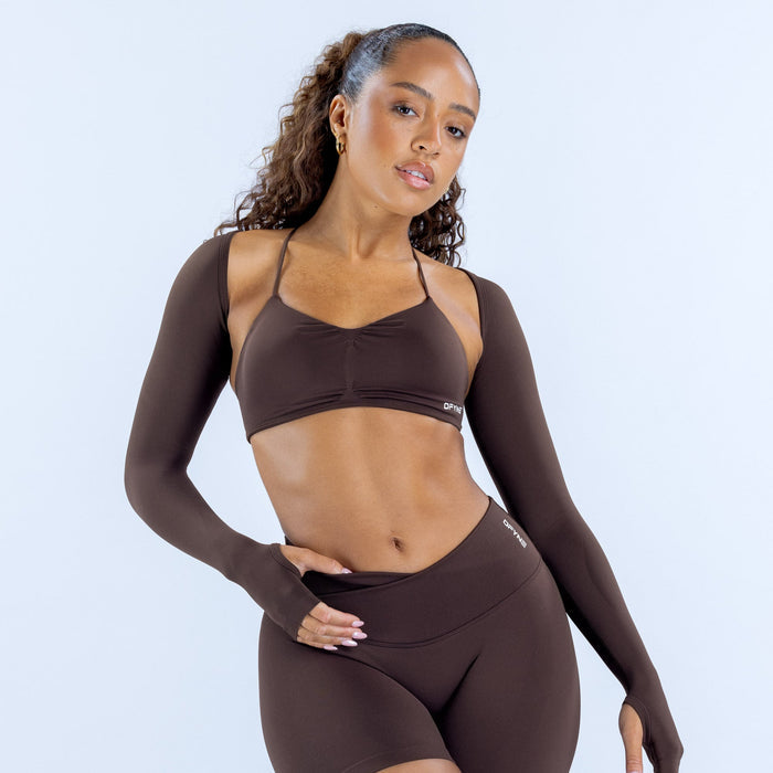 Dark brown long-sleeve shrug over sports bra, cropped fit