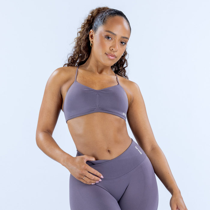 Women's seamless sports bra in lavender with thin straps and front crossover seam