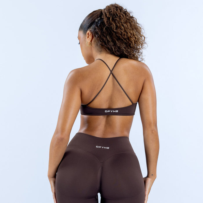Dark brown sports bra with crisscross back straps and logo band